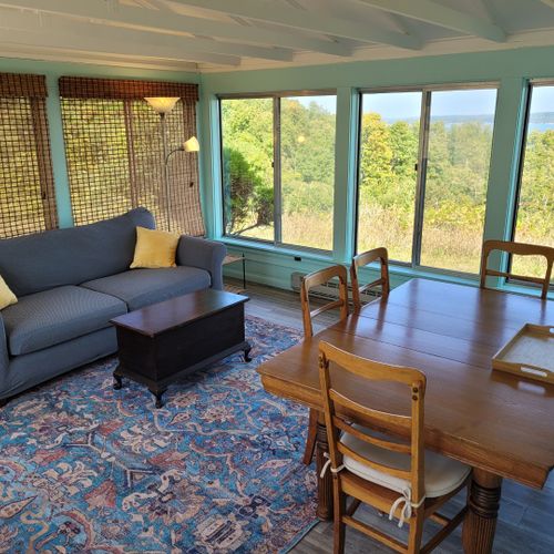Overview:  the home also has a lovely sunroom with a dining / game table, sofa, chairs, and another great view of crystal lake!