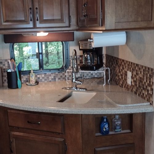 Kitchen:  the home has a cute little kitchen with a refrigerator, sink, counter, stove, oven, and microwave. There is also a collection of cooking and dining utensils provided.