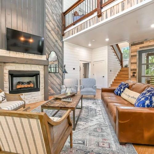 The living room is centered around the luxury fireplace and flat screen tv.