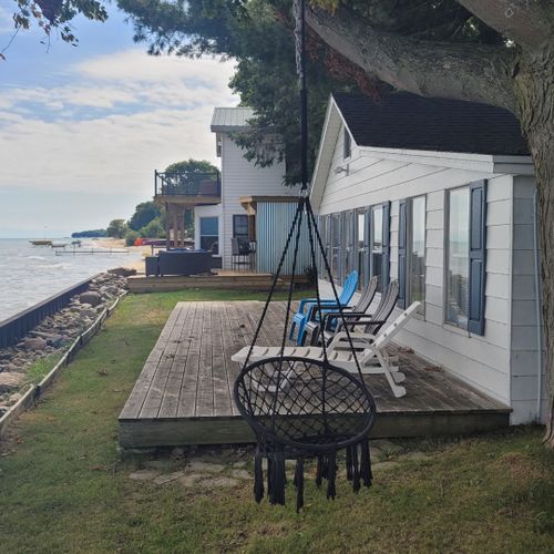 Exterior:  the private swing, deck, and beach at the beach house.