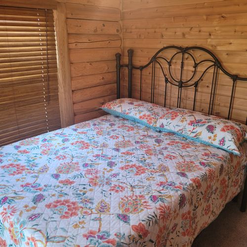Bedroom #2:  the second of the two cute and comfy downstairs bedrooms with a queen bed, a closet, and a ceiling fan