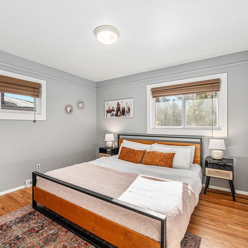 Step into this serene bedroom, where warm earth tones create a calming and inviting atmosphere and enjoy the comfort of the king bed..