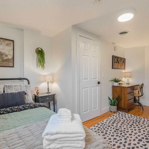 - snuggle up in a dreamy bed framed by soft lighting and playful textures
- knock out emails or plan adventures at your own stylish wood desk setup
- touches of greenery, cozy throws, and modern decor make this space pop