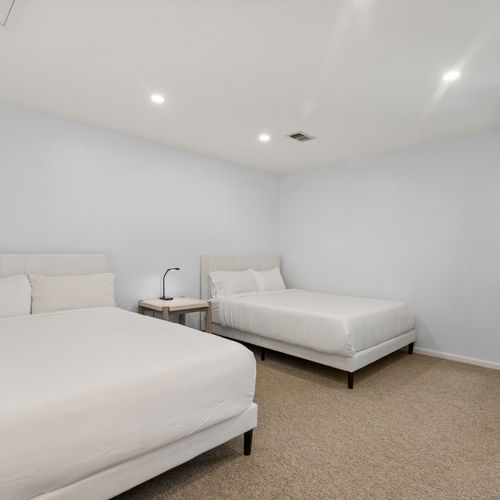 Comfortable room with two beds and desk—perfect for remote work or study time.