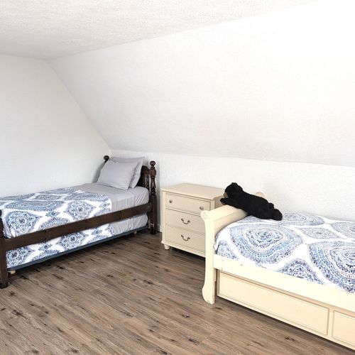 BEDROOM #4 (UPPER LEVEL):  Features 3 trundle beds, which are single beds with a second single bed that rolls out from underneath.  As such, the bedroom effectively has 6 single beds.