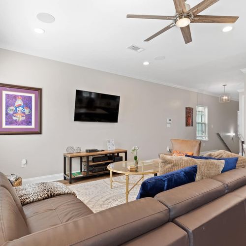 Spacious living room w/ a large sectional — room for everyone to kick back & relax.