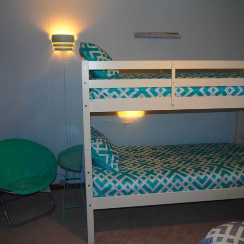 Bedroom #2:  features a full-size bed, bunk bed (i. E. 2 single beds on top of each other), ceiling fan, dresser, mirror, and closet.