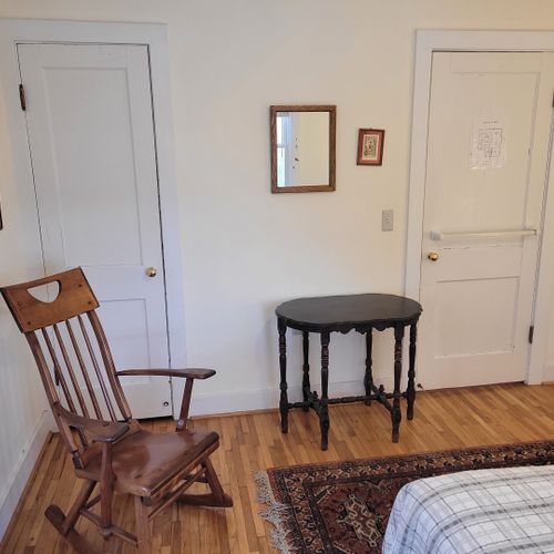 Bedroom #1 (main floor):  features a full-size bed, table, chair, dresser, and closet.