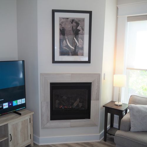 Living room:  gorgeous living room that features a gas fireplace and a large television with live streaming via hulu, netflix, and disney+.