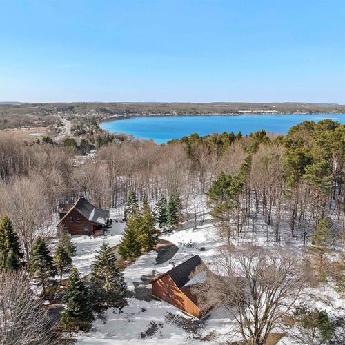 Exterior:  an aerial view of the cabin with crystal lake in the background.