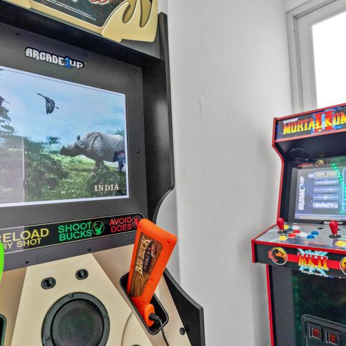 Explore your love for gaming in this stylish space, showcasing classic arcade machines and a magical glow from LED lights.