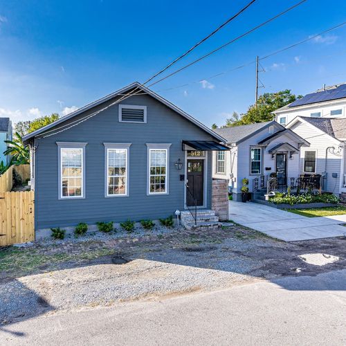 Charming blue cottage exterior w/ great curb appeal — a true Uptown gem.