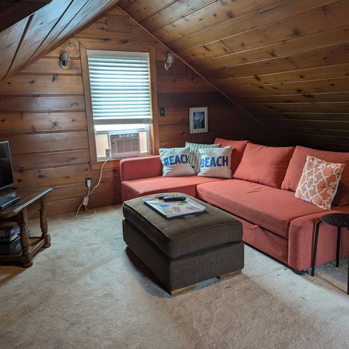 BEDROOM #4 (LARGER HOUSE, SECOND FLOOR):  This is a large private area with its own sectional sofa, television, desk, window A/C unit, and two twin beds.