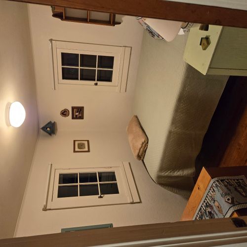 Bedroom #1:  features a full-size bed, nightstand, lamp, and dresser.