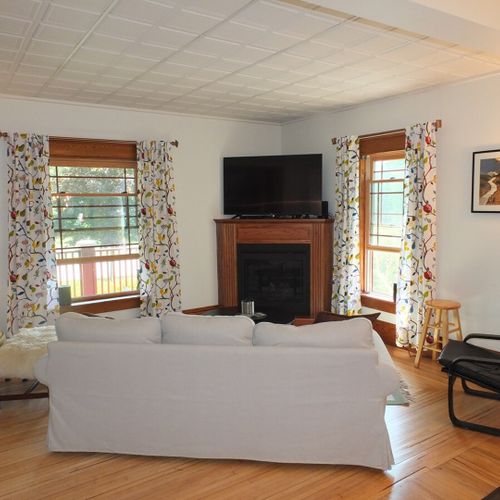 Living room:  the living room features a nice new sofa, a coffee table, a couple chairs, a large flat screen television, gas fireplace, and lots of natural light from the windows!