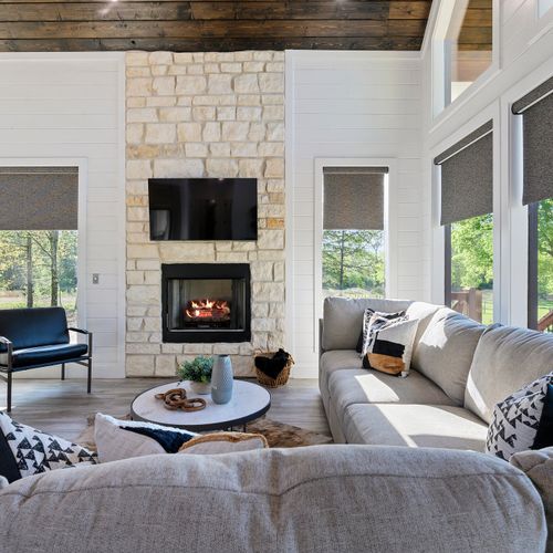 The oversized sectional and additional lounge chair sit around the gas fireplace!