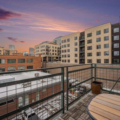 Step out onto a spacious balcony to enjoy purple skies at sunset.