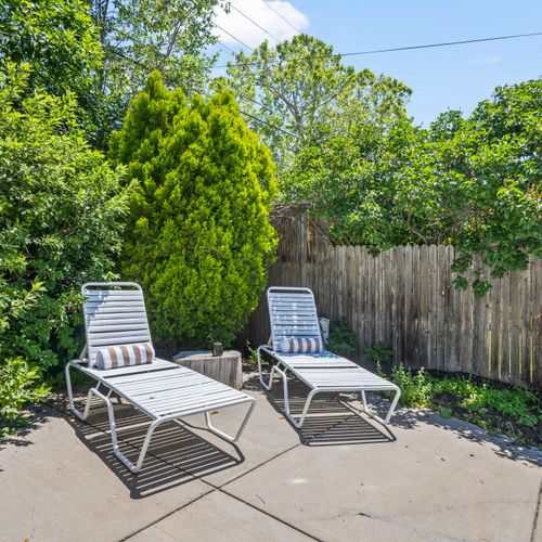 Unwind in cozy loungers beside the pool, surrounded by greenery and privacy.
