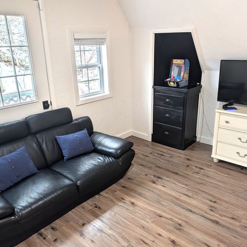 LIVING ROOM #2 (UPPER LEVEL):  Very fun and casual living room / game room on the upper level with a sofa, television, and lots of games in the drawers.