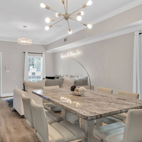 Bright dining area w/ marble-top table, perfect for sharing meals together.