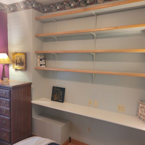 Bedroom #1 (main floor):  features a full-size bed, lots of shelving, a ceiling fan, and a dresser.