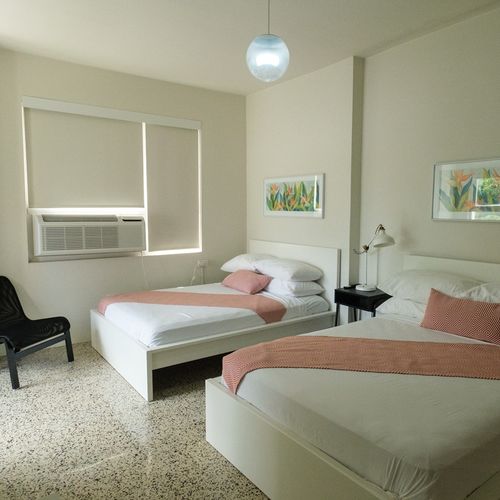 Ideal for friends or family, this room offers two comfortable twin beds, each beautifully made with fresh linens, ensuring a restful night's sleep for everyone.