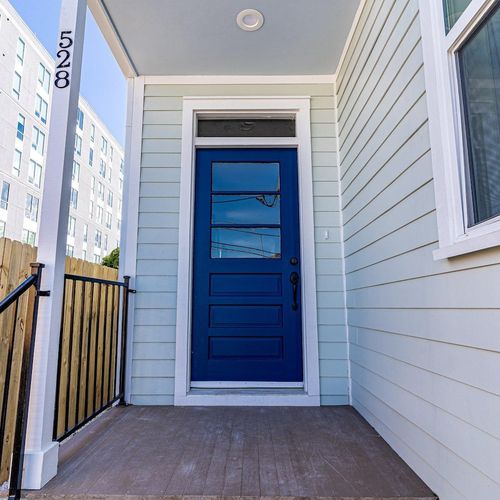Step out through the bold blue door into the backyard for some sun & fun.