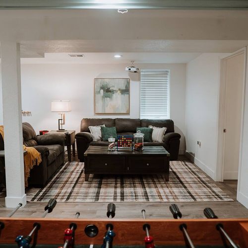 - comfy couches, plush throws, and soft lighting create a cozy vibe
- enjoy casual games like connect four or relax with a film on the projector
- stylish decor and a patterned rug add charm to this welcoming space