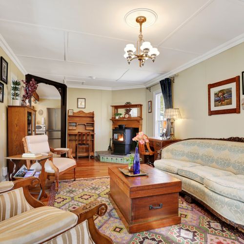 A snug living space anchored by a classic wood fireplace.