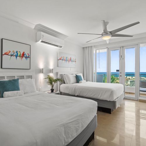 Spacious studio with two comfortable beds and a private balcony boasting stunning ocean views. Ideal for a luxurious getaway.