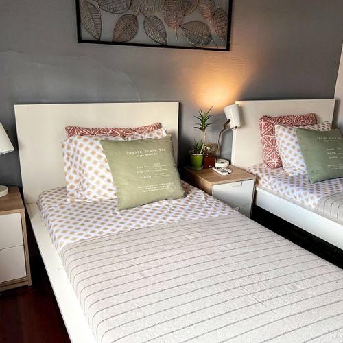 Soft, inviting bed dressed in light linens — a calm corner to recharge.