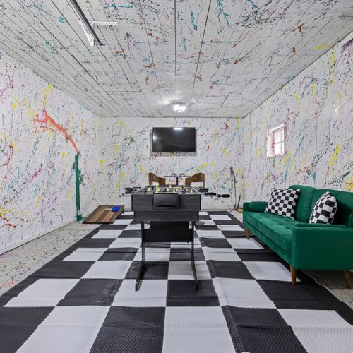 Fun game room with foosball action, big tv, and inviting design touches.