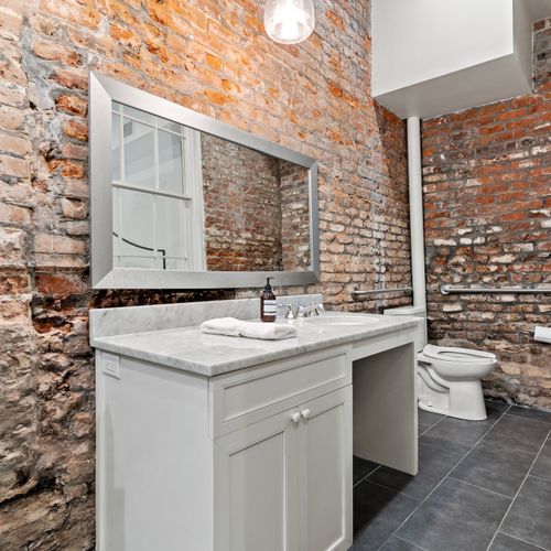 Bathroom space with historic brick walls