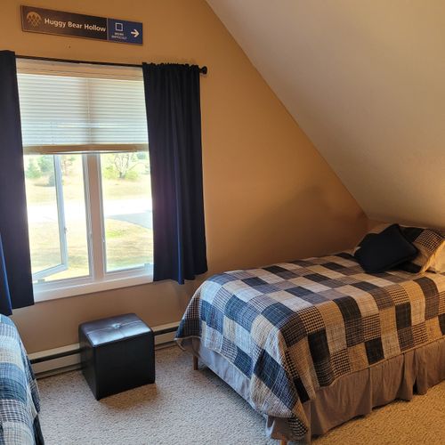 BEDROOM #2 (SECOND FLOOR):  Features a queen-size bed, 2 single beds, ceiling fan, a dresser, mirror, 2 nightstands, lamp, stool, and private live streaming television (via Sling).