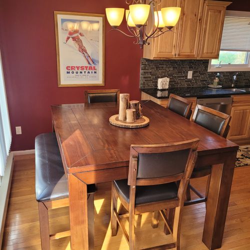 DINING TABLE:   The home has a high-top dining table with seating for up to 6 adults.