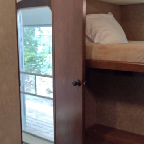 Bedroom #2:  includes 3 twin beds, a dresser, and a television.