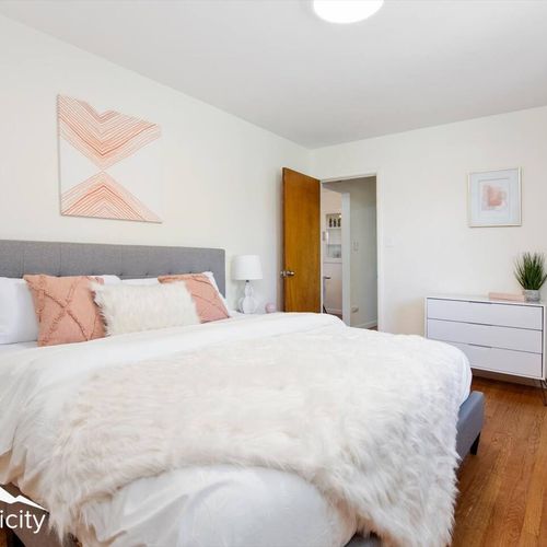 - cozy king bedroom with soft textures, peachy accents, and calming wall art
- relax in a plush bed topped with a faux fur throw and supportive pillows
- stylish white dresser and natural light complete the peaceful retreat