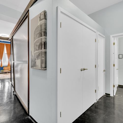 Spacious and inviting—this hallway seamlessly connects the living area to the rest of your stylish New Orleans retreat, offering a glimpse of the vibrant spaces ahead.