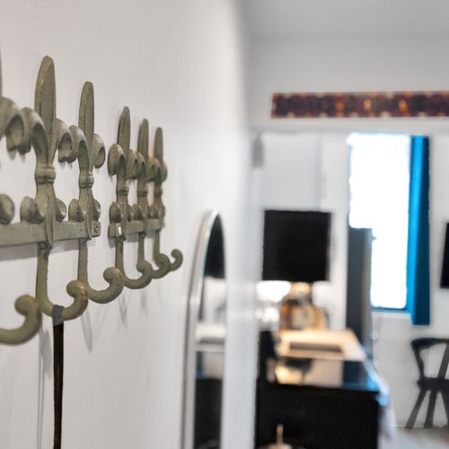 Vintage brass hooks mounted on a teal wall — stylish & practical for everyday use.