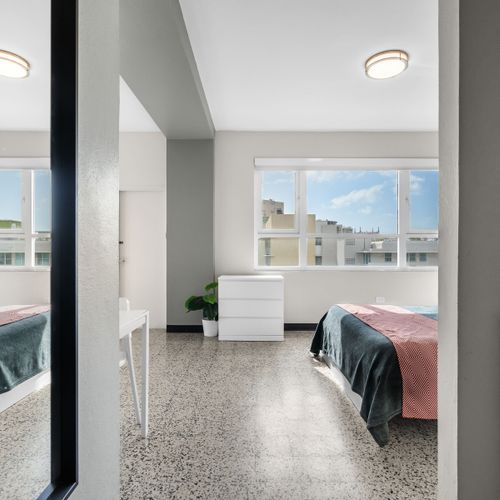 Experience a blend of contemporary style and cozy comfort in this inviting bedroom, featuring a comfortable bed and soothing ambiance for a relaxing stay