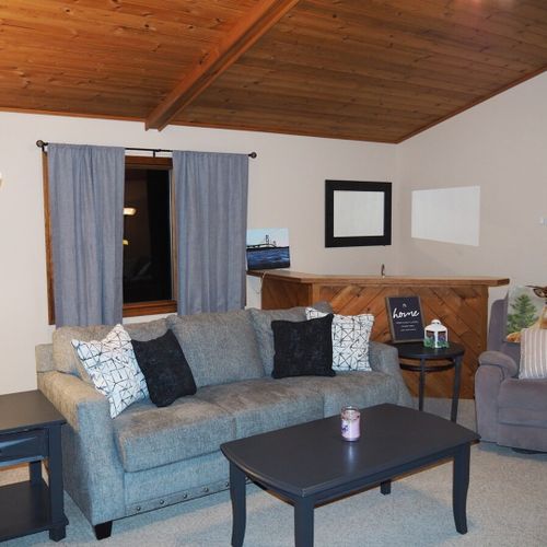 Living room:  large and comfy living room with a ceiling fan, lots of comfy seating, two coffee tables, live streaming television with roku, and a wet bar.
