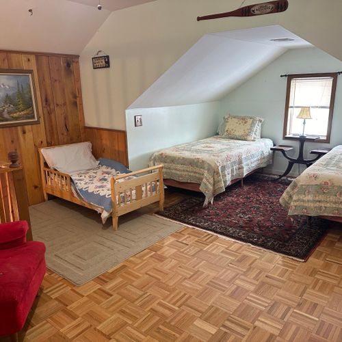 Loft area:  outside of the upstairs bedroom there is a cute loft area with 2 single beds, a small child's bed, and a chair.