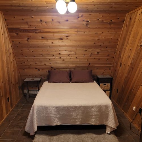 Bedroom #1 (main floor):  features a queen-size bed, private en suite bathroom, desk, dresser, mini-fridge, microwave, portable a/c unit, and its own private entrance.