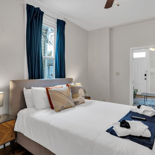 Bedroom w/ plush bedding & layered pillows for a restful night's sleep.