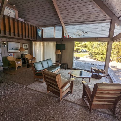 Overall:  the large open comfy living room with a tv and fireplace plus lots of windows for plenty of sunlight