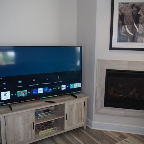 Living room:  gorgeous living room that features a gas fireplace and a large television with live streaming via hulu, netflix, and disney+.