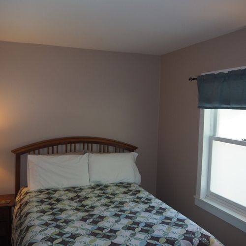 Bedroom #1:  features a queen-size bed, nightstand, lamp, dresser, mirror, closet, and television.