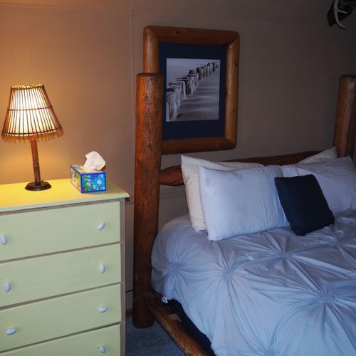 Bedroom #4 (second floor):  features a queen-size bed, private television, sofa bed, comfy chair, ceiling fan, baby crib, and a dresser.