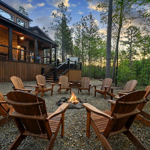 Firepit in the back yard with Adirondack chairs.
