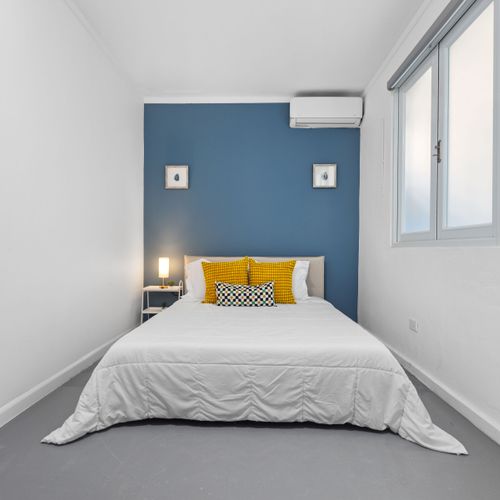 Condado | Puerto Rico Vacation Rental 36 Unwind in Style: Cozy bedroom featuring a plush king-sized bed and elegant, modern decor, designed for ultimate relaxation after a day of exploration.